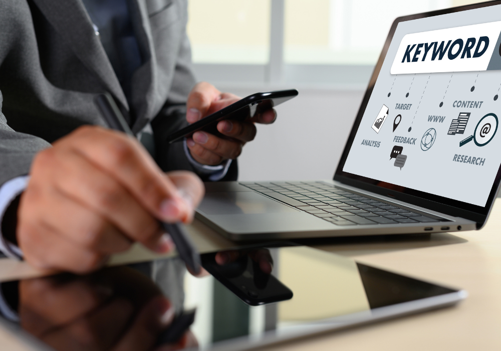 Person using laptop to find local SEO keywords with map and analytics on screen